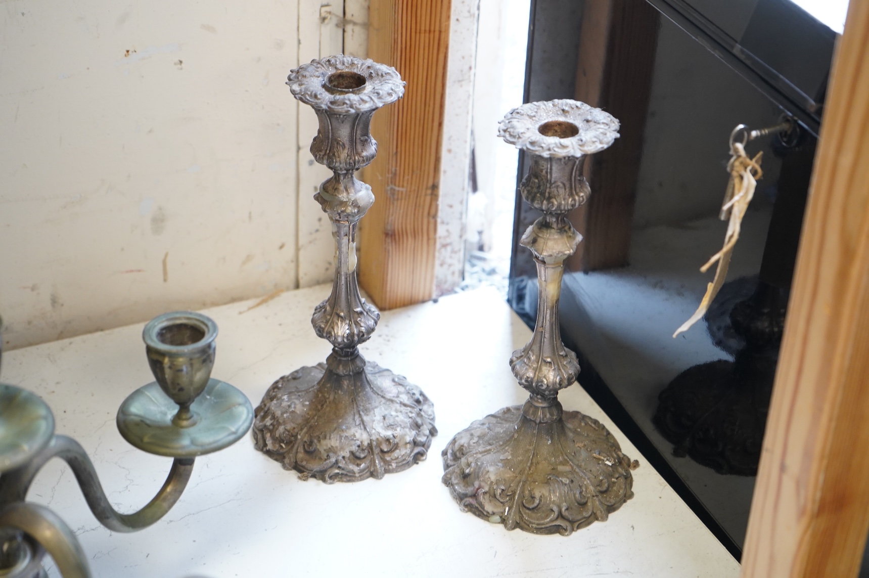 A pair of silver plated candlesticks, a four branch, three light candlestick and a copper cauldron